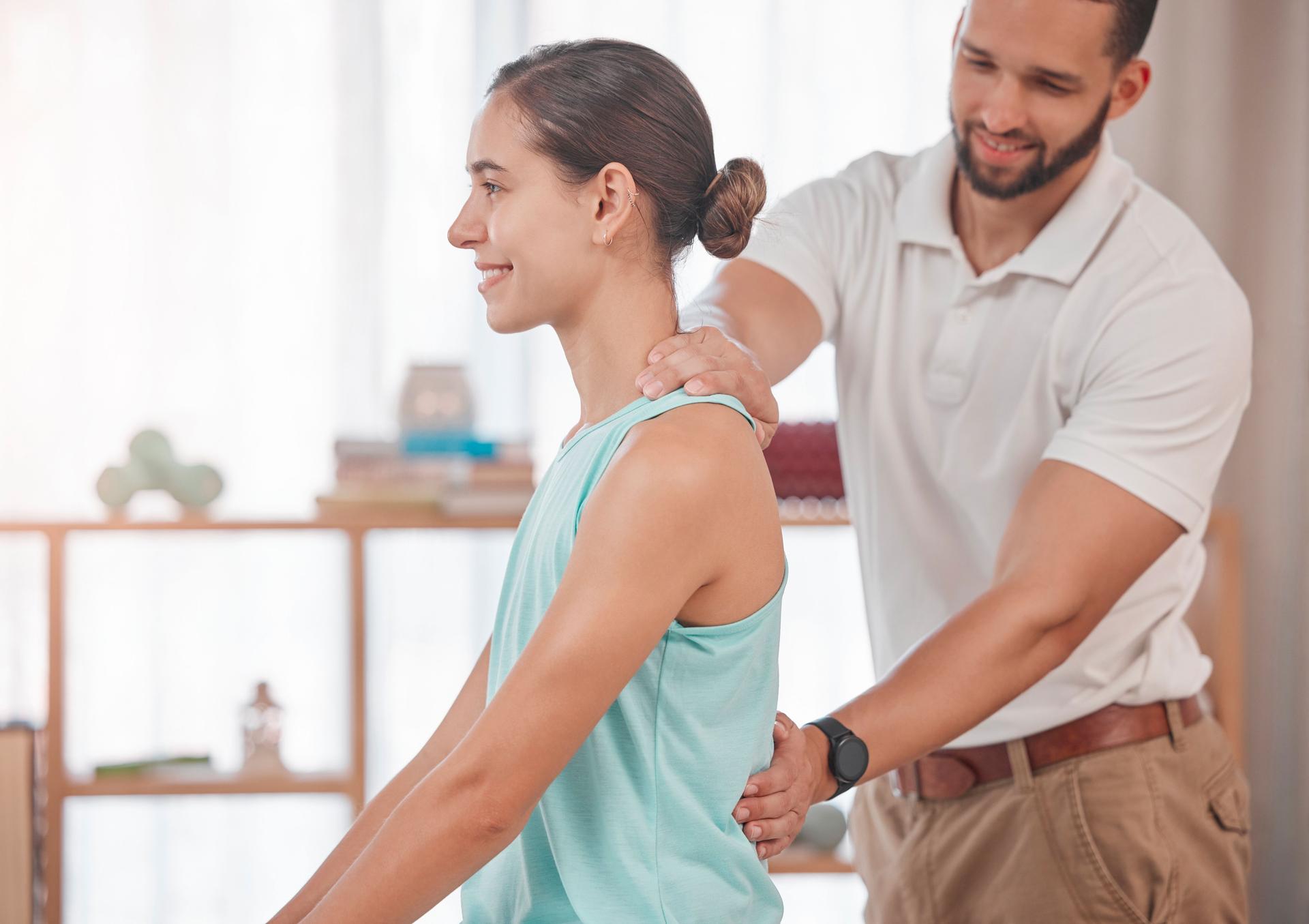 Physiotherapy, chiropractor and consulting with woman and doctor for healthcare, medical or sports therapy. Healing, wellness and training with spine of patient and man help for back injury exam