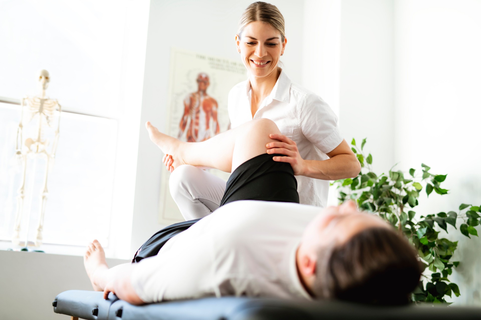 A Modern rehabilitation physiotherapy woman worker with client